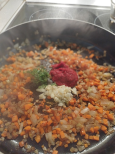 Adding the garlic, tomato paste, and thyme for another minute or so- the-sauce-lab.com