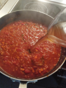 Adding the beef stock to the pan