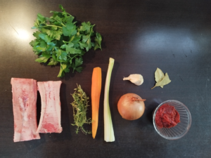 Ingredients used for the beef stock: From left to right- Beef bones, thyme, carrots, celery, white onion, garlic, bay leaves, tomato paste and on top- parsley
