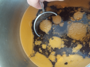 After one night in the refrigerator, the fat will solidify and can be easily removed.