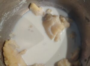 Warm milk is gradually whisked into the roux, transforming it into a smooth, creamy béchamel sauce.