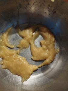 Flour is gradually added to melted butter while stirring continuously, forming a smooth, pale roux over gentle heat.